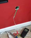 Plastic Coated Steel Fish Tape Wire Puller For Wall Installations Go-To 32 Ft 10 M Threader in use, pulling wire through wall.