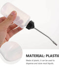 Person holding a plastic oil can with metal spout from the Three Piece Sewing Machine Oil Can Set With Iron Spout And Cap For Precise Lubrication On Sewing Machines Engines And Machinery Maintenance Tools And Dispenser For Handheld Use And Everyday DIY Repairs.