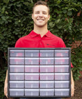 Man holding a 24-Drawer Plastic Storage Cabinet For Garage Organization And Craft Storage, Small Parts Organizer, Black