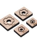 Plum Blossom Shaped Leather Die Cutter 4 Piece Set For Handmade DIY Leather Craft, shown with wooden bases and metal outlines on white background