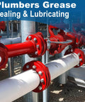 Industrial pipes with red flanges, showcasing plumbers grease application for sealing and lubricating connections.