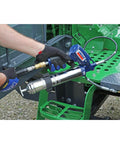 Heavy Duty Pneumatic Grease Gun With 30 Inch High Pressure Hose And 6000 PSI Power in use on industrial machinery
