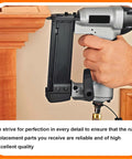 Pneumatic air hammer in use for nailing wood, held by hand. Industrial tool demonstrating precise workmanship.