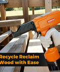 Pneumatic Nail Puller Denailer For Reclaimed Wood Pallets Fences Barn Wood And Decks With Lightweight Aluminum Body At 80 120 PSI Provides Efficient Nail Extraction To Salvage Boards From Soft To Medium Hard Woods, shown in use on a wooden deck.