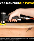 Person using pneumatic orbital sander kit 1 2 3 inch with 45 discs and 3 backing pads on wooden surface.