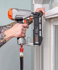 Person using Sixteen Piece Universal Air Hose Fittings And Quick Connect Kit with pneumatic tool near window frame in DIY setup