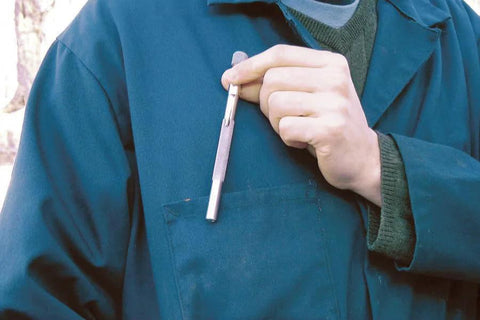Person holding Pocket Model Grease Joint Rejuvenator Tool By IPA Tools Innovative Products Of America against a blue uniform pocket.