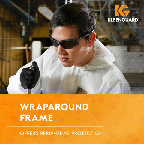 Man wearing Polarized Safety Glasses With Smoke Lenses Gunmetal Frame Unisex Case Included, shown in a work environment.