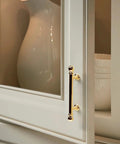 10 Pack Polished Brass Kitchen Cabinet Pulls 3 Inch Hole Center Solid Zinc Alloy Handles installed on cupboard in kitchen close-up