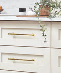 10 Pack Polished Brass Cabinet Pulls 7.5 Inch Hole Center Solid Zinc Alloy Drawer Handles installed on light wood drawers