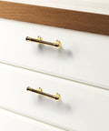 Installed view of 10 Pack Polished Brass Kitchen Cabinet Pulls 3 Inch Hole Center Solid Zinc Alloy Handles on white drawers