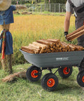 Person loading firewood into 4 Cu Ft Poly Garden Cart Dump Wagon with 600 lb Capacity Heavy Duty 4 Wheel Yard Cart outdoors