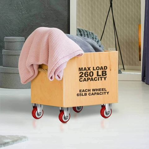 12 Pack 2 Inch Rigid Caster Wheels with red polyurethane tires mounted on a wooden cart for safe, quiet rolling.