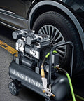 Industrial Air Blow Gun with Brass Adjustable Air Flow Nozzle and 2 Steel Extension connected to compressor near car tire.