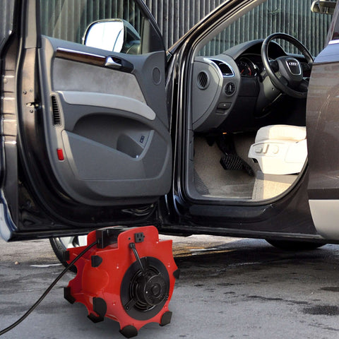 Heavy Duty 1600 Watt Blower Fan With 3 Speeds And 4 Angle Adjustments For Basements Cars And Garages Portable 120V Air Mover With Circuit Breaker And Motor Overload Protection From Stalwart shown blowing air into a car