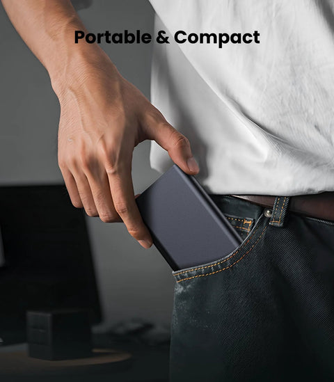 Person placing a portable and compact device into jeans pocket, demonstrating ease of carry and utility in everyday situations.