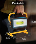 Person holding Rechargeable 100W LED Work Light With Beast Mode Brightness And 7000LM Output, Cordless Flood Light With Stand