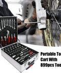 Portable tool cart with 899pcs tools, open view showing assorted hand tools, wrenches, pliers in a toolbox, mechanic working on bicycle wheel.