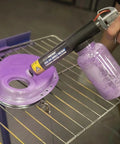HotCoat PCS-250 Powder Coating System in use on metal part, showing clear viewing bottle, dual voltage settings, and fluidizing action.