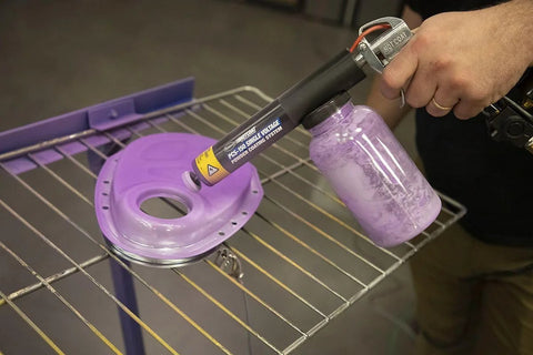 HotCoat PCS-250 Powder Coating System in use on metal part, showing clear viewing bottle, dual voltage settings, and fluidizing action.
