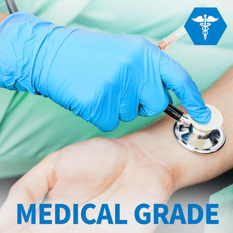 Blue nitrile exam gloves on a gloved hand using a stethoscope in a medical setting.