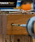 Power Pro Premium Exterior Wood Screw being drilled into wood, #10 x 6 Inch bronze deck screws with T-25 Star Bit.