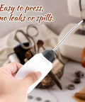 Person holding Two Pack 120ml Sewing Machine Oil Can Set with Precision Long Nozzle Lubricant Dispenser, easy to press, no leaks or spills.