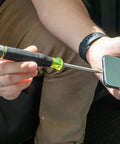 Person using All-In-One 27-In-1 Precision Screwdriver Set For Apple Device Repairs With Rare-Earth Magnet Barrel on a smartphone.