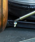 Close-up of All-In-One 27-In-1 Precision Screwdriver Set For Apple Device Repairs with tip near a small screw