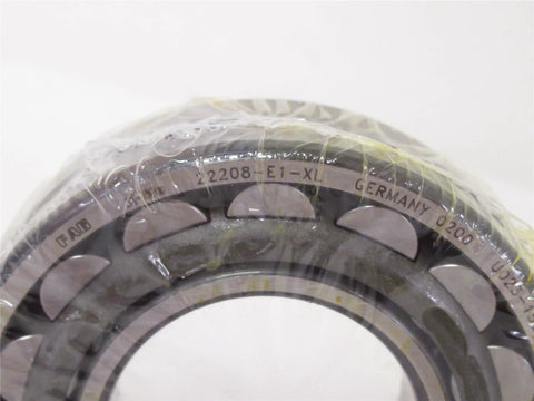 Close-up of high precision spherical roller bearing 22208 E1 XL 40x80mm with sealed design, showcasing markings and structure.