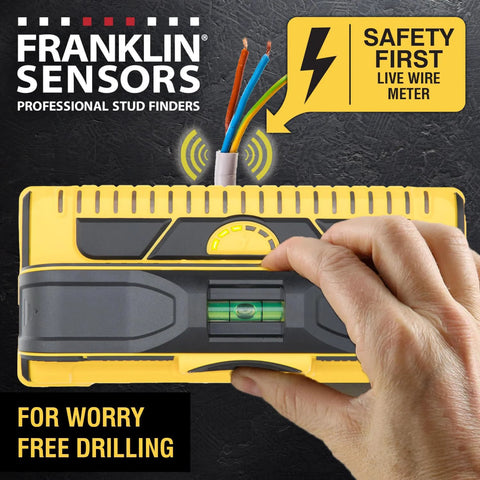 Hand using ProSensor M210 13-Sensor Stud Finder with live wire detection on wall for safe drilling