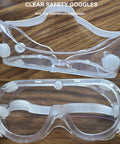 Protective Safety Goggles Anti Splash Wide Vision Fits Over Prescription Glasses with clear lenses on wood surface.