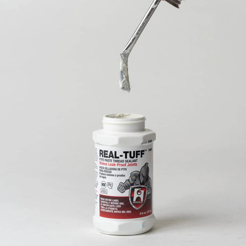 Real-Tuff Heavy Duty PTFE Pipe Thread Sealant in white for all metals PVC CPVC and ABS plastics, 8 oz bottle with applicator
