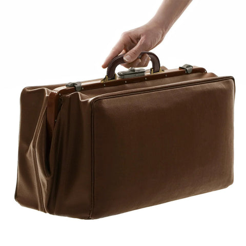 Hand holding a suitcase with a PU Leather Luggage Handle Replacement Strap For Travel Bags Guitar And Musical Boxes Gift Boxes Vintage U Shape