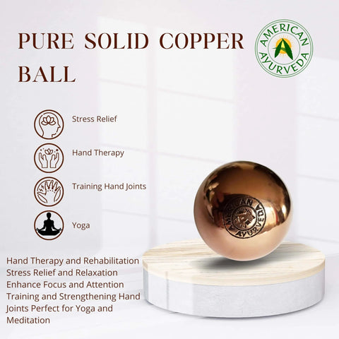1.5 Inch Pure Solid Copper Ball 2 Pack Sphere Orb with therapy benefits on a wooden stand