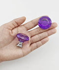 Hand holding two Purple Diamond Crystal Cabinet Knobs 1.2 Inch with Chrome Alloy Bases, showing crystal glass detail and chrome base.