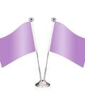 Two purple desk flags on a silver stand with round finials against a white background.