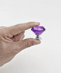 Person holding Purple Diamond Crystal Cabinet Knob 1.2 Inch with Chrome Alloy Base, part of 6 Pack Glass Drawer Pulls for Cabinets.