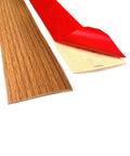 Self Adhesive Flat Floor Transition Strip, Yellow Oak, showing adhesive backing and wood-like finish