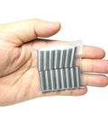Hand holding a pack of 15 Quarter Inch Dowel Pins Kit One Inch Long Metal Shelf Pins for Shelves Bunk Beds Woodworking Alloy Steel Bearings.
