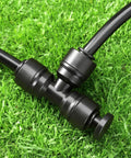 Installed 20 Pack One Quarter Inch End Plugs For Quick Connect Fittings in garden irrigation system on grass with tubing.
