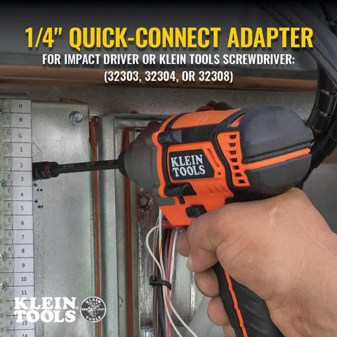 Person using a Klein Tools impact driver with 1/4 inch quick-connect adapter to install wiring on an electrical panel.
