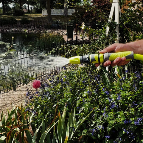 Garden Hose Quick Connect Fittings Kit With Two Piece Coupler And Plug For Standard Three Quarter Inch Hose Threads ZillaGreen Compatible With Flow Stop Couplers And Water Hose Adapters Durable Quick Connect Set For Easy Watering in use watering garden plants by pond.