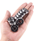 Hand holding 10-pack Half Inch Bore R8-2RS Double Sealed Ball Bearings for electric motors, wheels, home appliances, and garden machinery.