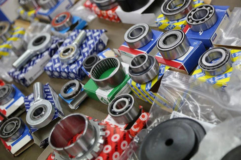 Assorted precision bearings, including Radial Deep Groove Ball Bearing 6416M, arranged for shipping in 3-5 days on a table.