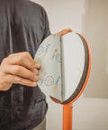 Radius360 Round Sanding Tool With Interchangeable Center Hub 9 Inch in use with sanding pad being attached by hand