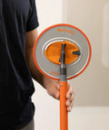 Person holding Radius360 Round Sanding Tool With Interchangeable Center Hub 9 Inch, showcasing handle and pad close-up.