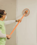 Man using Radius360 Round Sanding Tool With Interchangeable Center Hub 9 Inch on wall surface