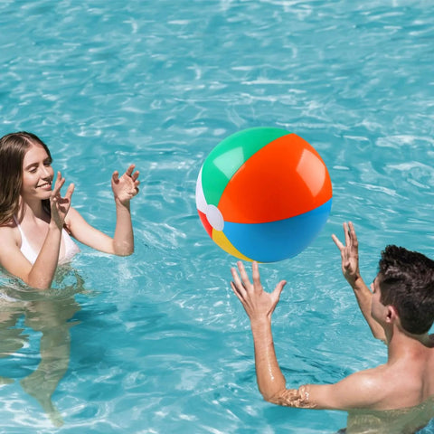 Two people playing with a 2 Pack Beach Balls, 20 Inch Beach Balls, Rainbow Color Pool Toys in a swimming pool.