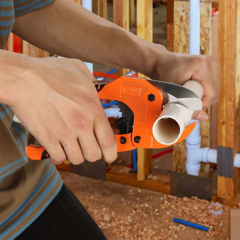 Ratcheting PVC Pipe Cutter for 1-1/4 in Pipes with Manganese Steel Body and Rubber Handle cutting a pipe